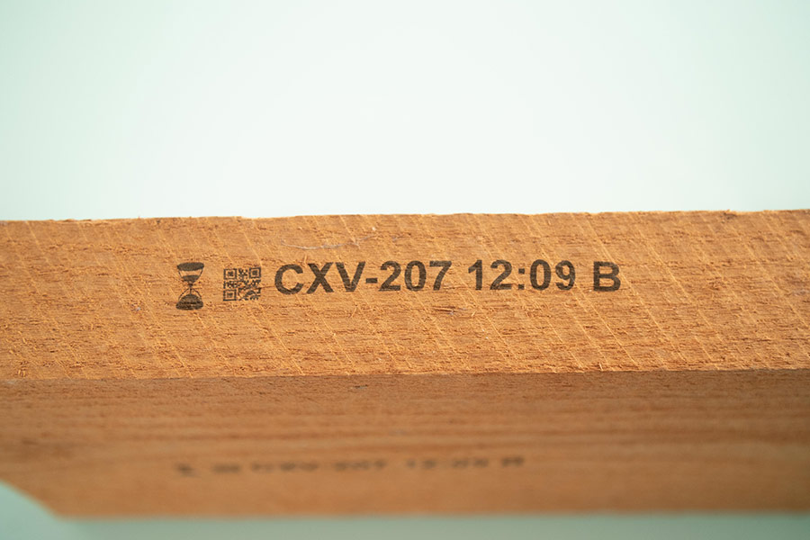 wood with graphic and part number and time