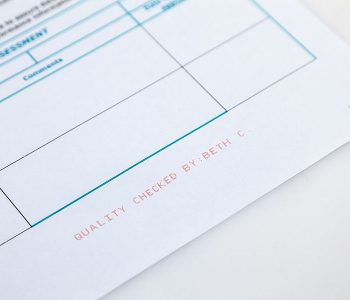 paper form with quality check red ink